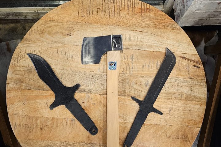 Wooden board with two knives and an axe in star pattern