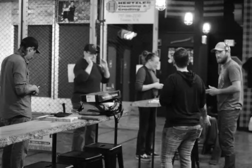 Group of people socializing in a casual indoor setting.